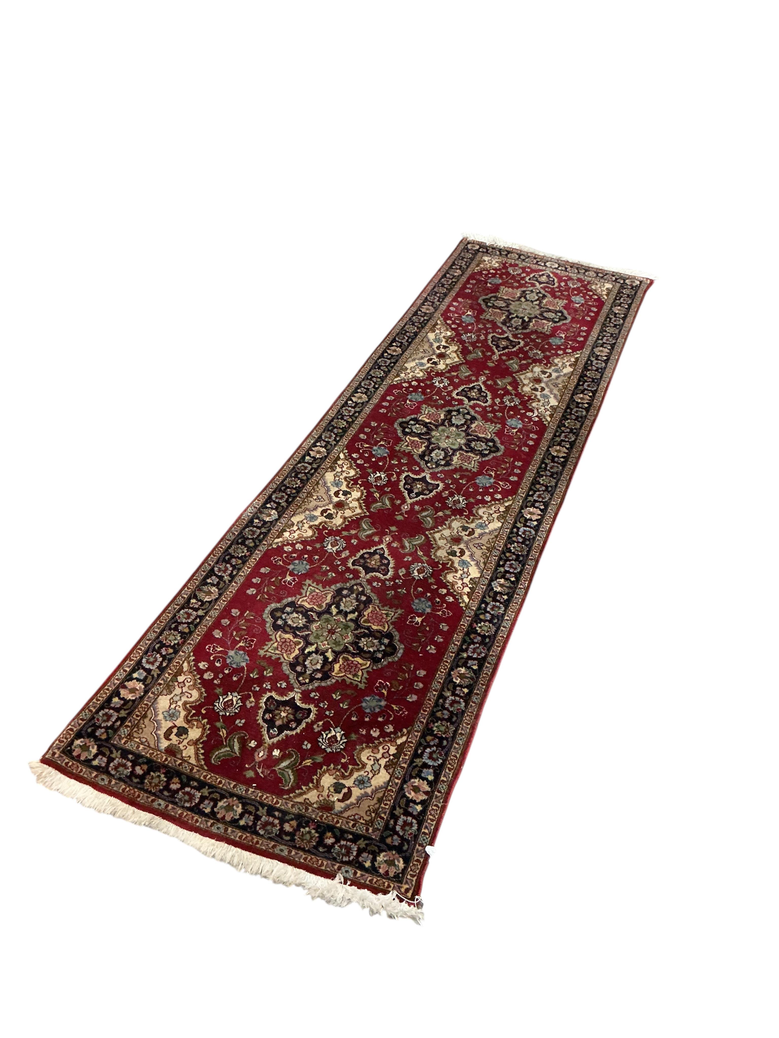 A North West Persian red ground runner, 310 x 55cm